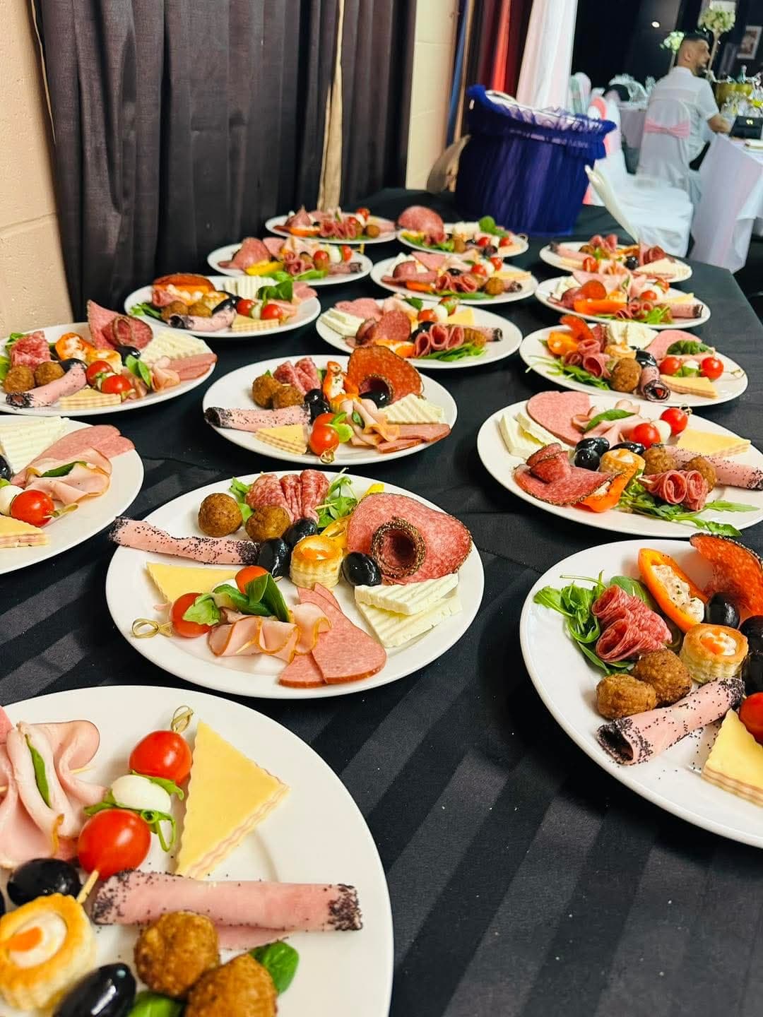 A table of individually plated cold starters laid out at an event