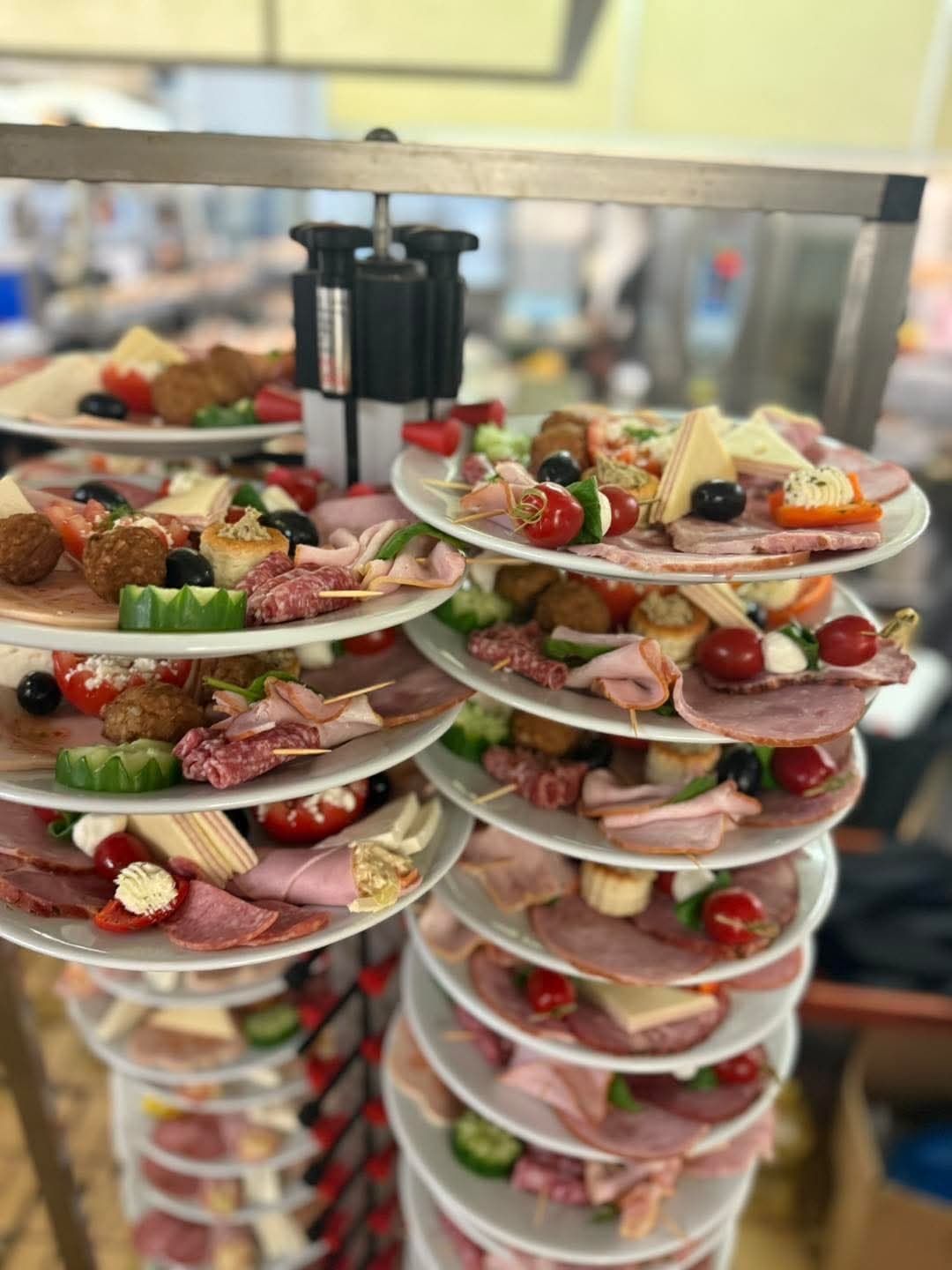 Stacked plates of cold starters arranged on a serving rack